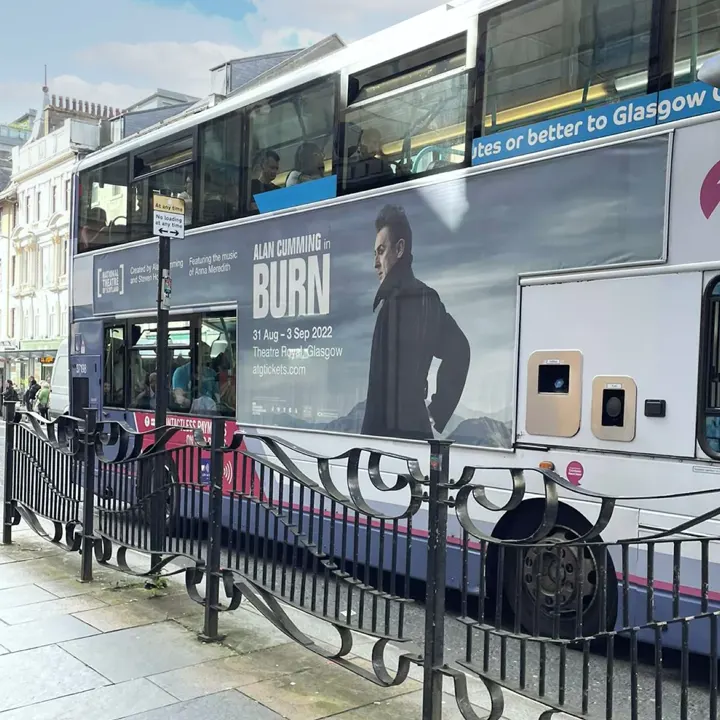 A side advertisement on a double-decker bus featuring Alan Cumming in the National Theatre of Scotland production of Burn at the Theatre Royal, Glasgow