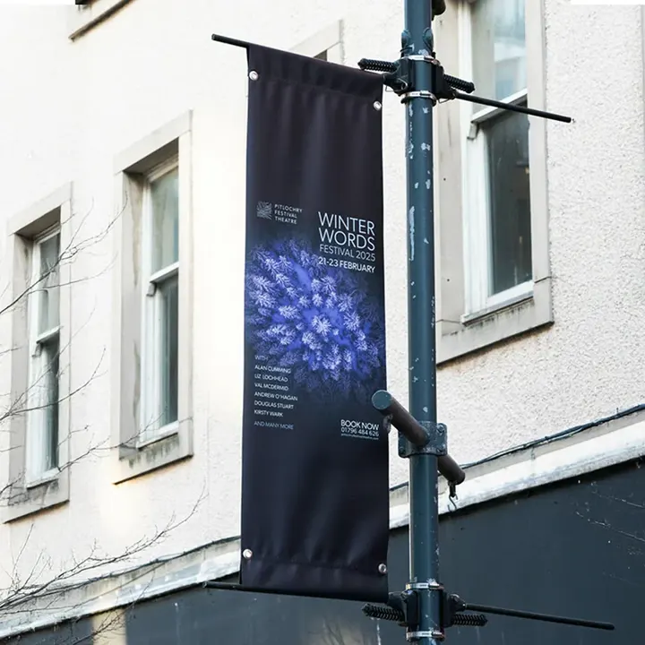 A Pitlochry Festival Theatre 'Winter Words Festival 2025' banner on a lamp post