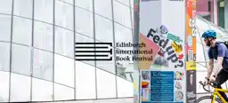 A city display pillar featuring an Edinburgh International Book Festival 2025 "Repair" campaign banner with the text Fed Up? and collage graphics