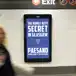 A digital billboard in a subway station displays a blue banner with white text that reads, The Worst Kept Secret In Glasgow - Coming Soon to the Southside.