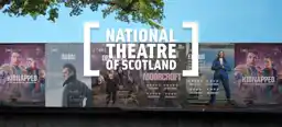 A brick wall displaying a collage of National Theatre of Scotland posters, including Kidnapped, Burn (starring Alan Cumming), Orphans, Moorcroft, and Exodus.