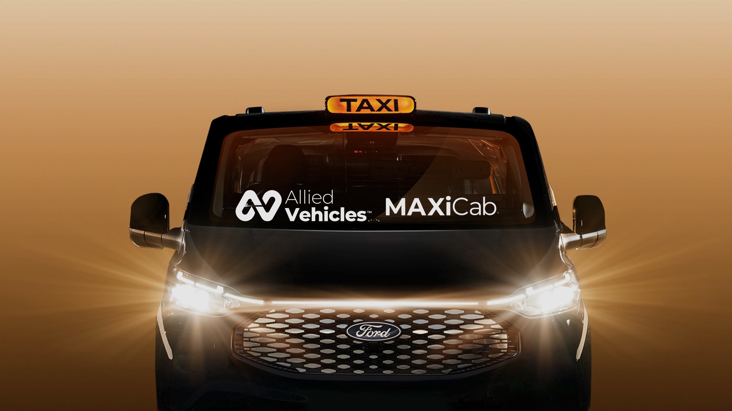 Front of the Allied Vehicles MAXICab taxi with its headlights on