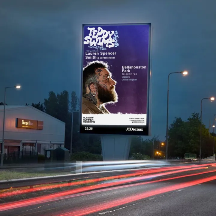 A digital billboard at night displays a concert poster for Teddy Swims at Bellahouston Park, Glasgow, on June 28, 2026.
