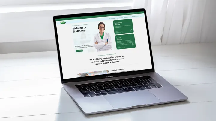 M&D Green Pharmacies website shown on a laptop
