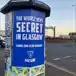 A printed poster pasted on a pillar in Glasgow, advertising Paesano Pizza as The Worst Kept Secret in Glasgow, Coming Soon to the Southside
