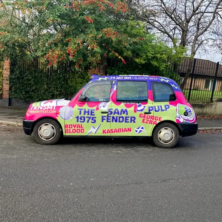 A taxi wrap promoting the 2023 TRNSMT Festival in Glasgow. The design lists headliners Pulp, Sam Fender, and The 1975, alongside artists like George Ezra, Kasabian, and Royal Blood.