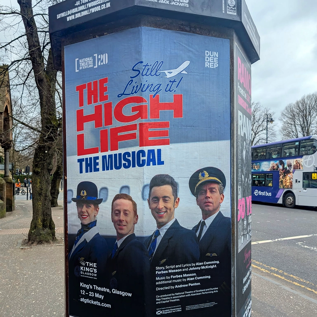 A street column poster for 'The High Life: The Musical' on a Glasgow street