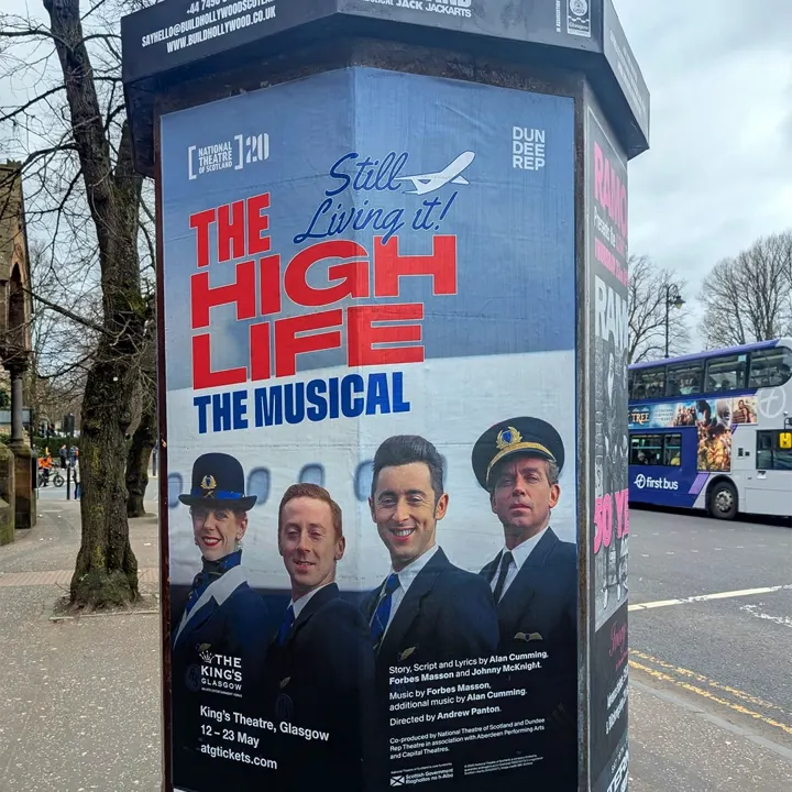 A street column poster for 'The High Life: The Musical' on a Glasgow street
