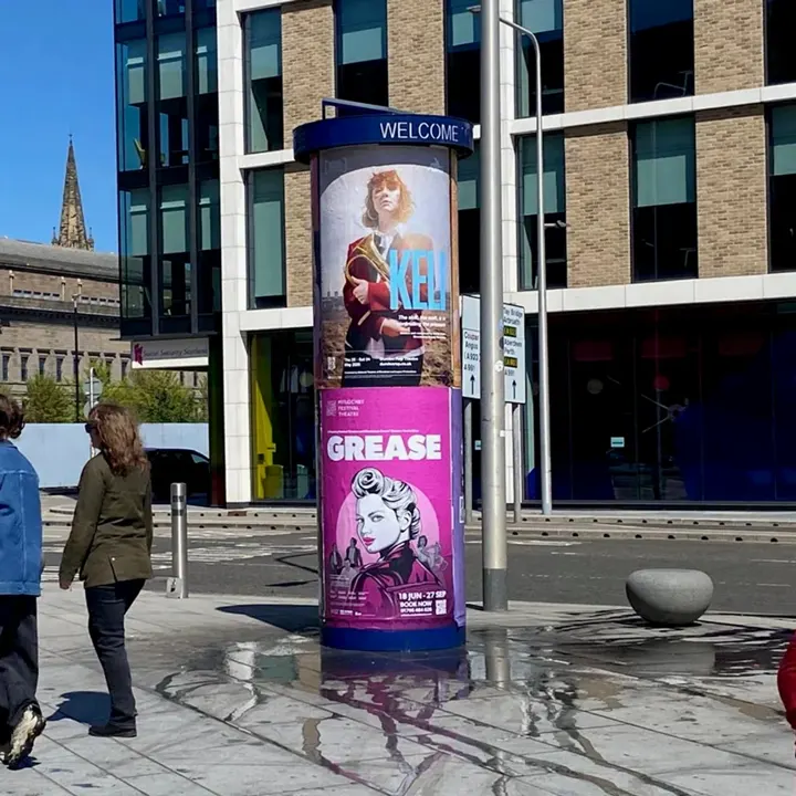A street column with 'Keli' and 'Grease' posters for Pitlochry Festival Theatre