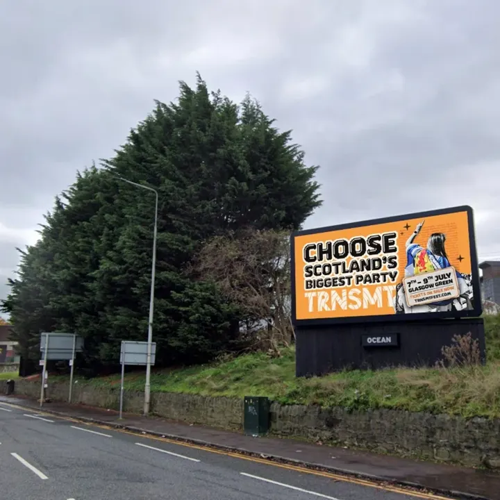A road-side digital banner reading: 'Choose Scotland's Biggest Party', promoting the TRNSMT festival