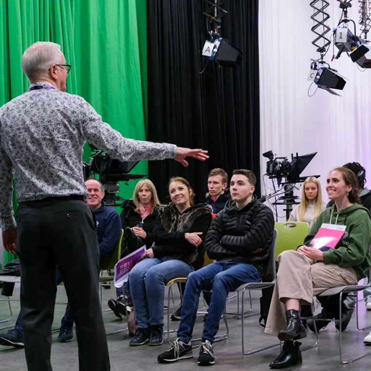A lecturer talking to prospective students in the City of Glasgow College TV studio
