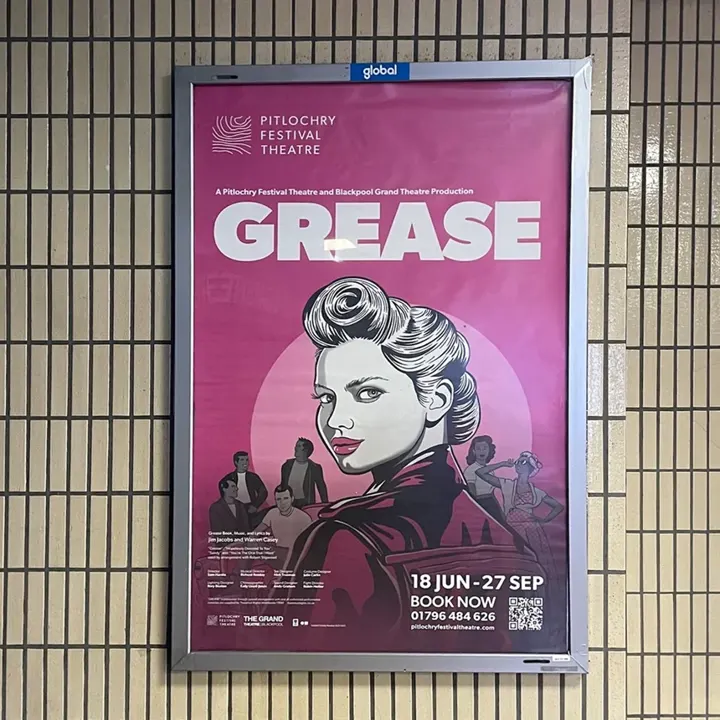 A Pitlochry Festival Theatre 'Grease' poster in a station, 18 June to 27 September