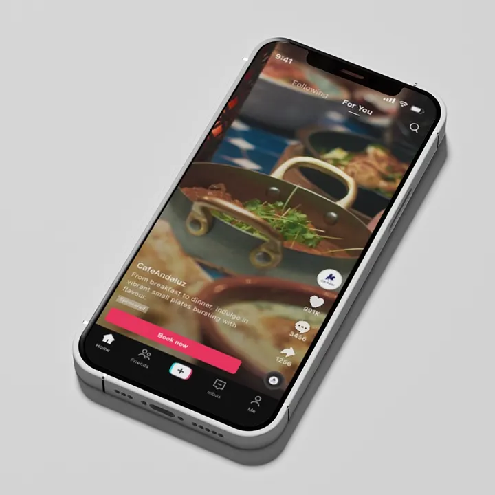 A phone showing a Cafe Andaluz TikTok video of a paella dish