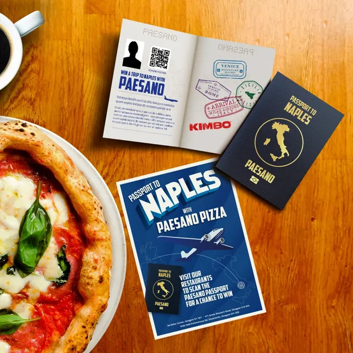 Paesano Pizza 'Passport to Naples' competition leaflets beside a Neapolitan pizza