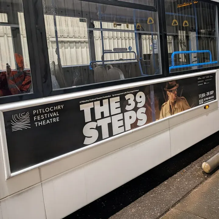 A tram with a Pitlochry Festival Theatre advert for 'The 39 Steps' on its side