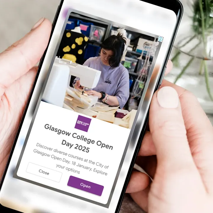 A phone showing a City of Glasgow College Open Day 2025 advert, Saturday 18 January
