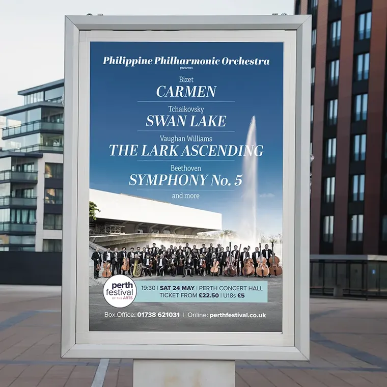 A silver-framed outdoor poster for the Perth Festival of the Arts promoting the Philippine Philharmonic Orchestra. It lists performances of Carmen, Swan Lake, The Lark Ascending, and Symphony No. 5 at Perth Concert Hall.