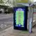 A vertical digital advertisement for TRNSMT 2023 at a city bus stop. The bright green poster lists the full three-day lineup for TRNSMT Festival at Glasgow Green, including George Ezra, Niall Horan, and Royal Blood.