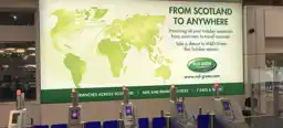 Large-scale OOH advertising, showing an M&D Green Pharmacy banner at airport security stops